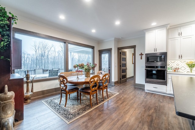 dining space featuring ornamental molding, dark wood-type flooring, recessed lighting, and baseboards