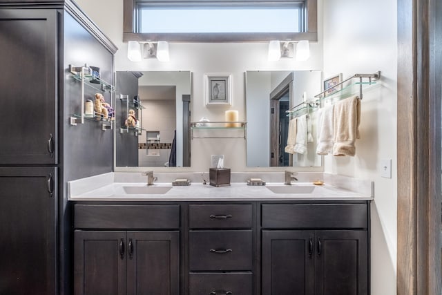 bathroom featuring double vanity, plenty of natural light, and a sink