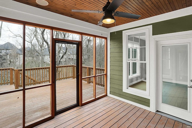 unfurnished sunroom featuring a ceiling fan and wood ceiling