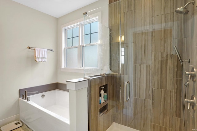 bathroom with a stall shower and a bath