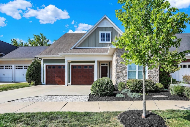 craftsman-style house with board and batten siding, driveway, and an attached garage