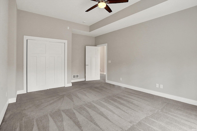 unfurnished bedroom featuring carpet floors, visible vents, and baseboards