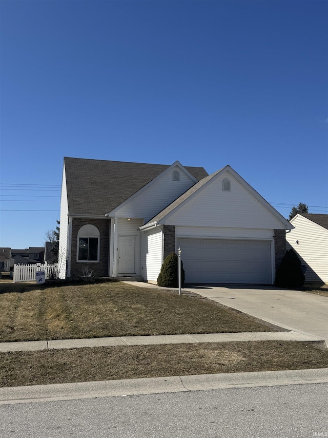 ranch-style house featuring a garage and driveway