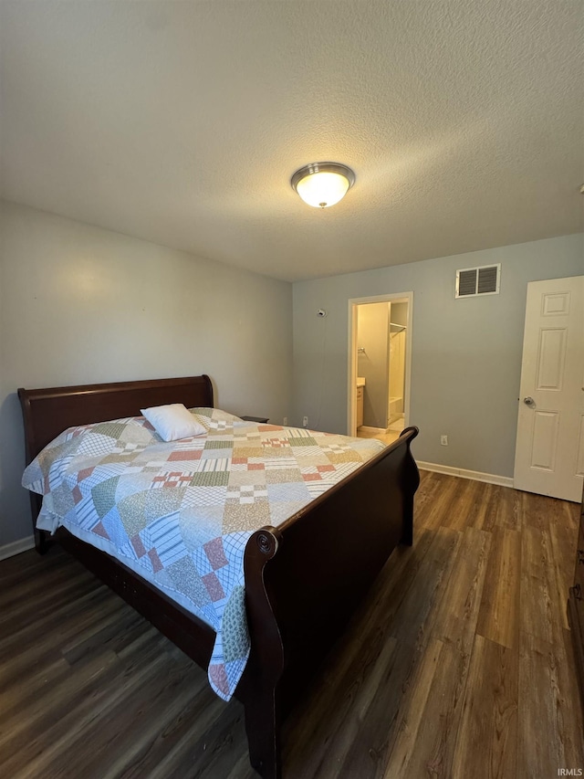 bedroom with baseboards, a textured ceiling, visible vents, and dark wood-style flooring