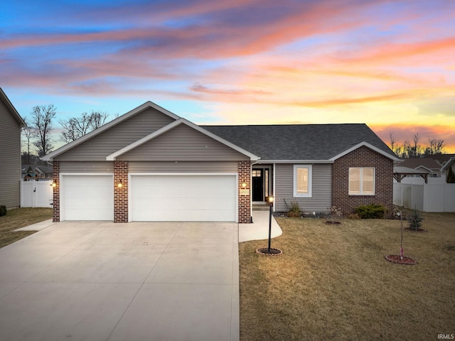 ranch-style house featuring a garage, brick siding, driveway, and fence