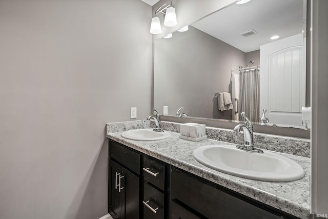 bathroom with double vanity, a sink, visible vents, and a shower with curtain