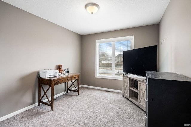 office space featuring baseboards and light colored carpet