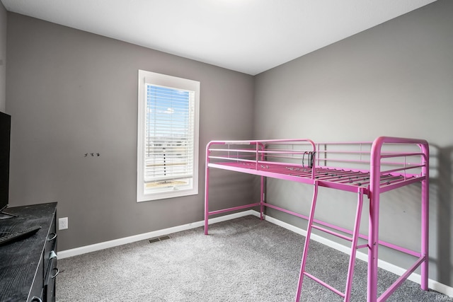 unfurnished bedroom featuring visible vents, baseboards, and carpet flooring