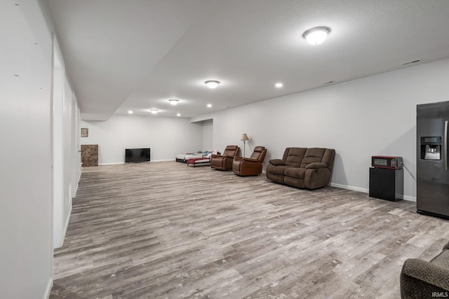 sitting room with recessed lighting, wood finished floors, visible vents, and baseboards