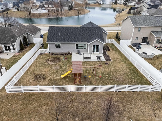 birds eye view of property with a water view and a residential view