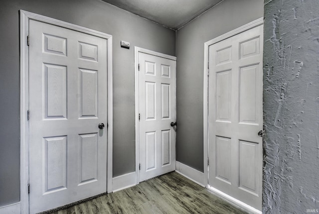 interior space with wood finished floors and baseboards