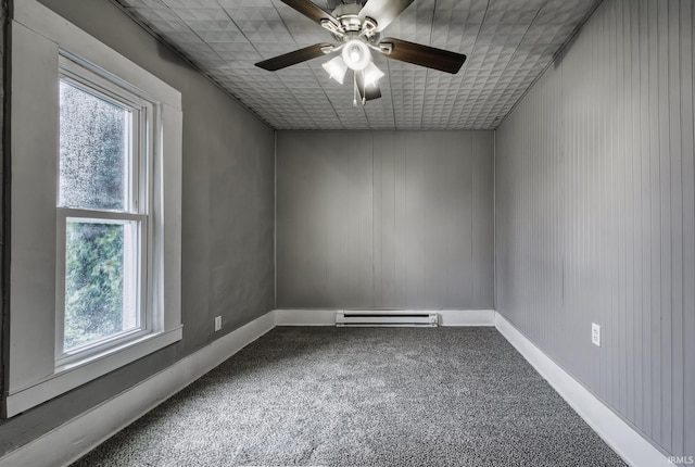 carpeted spare room with a baseboard radiator, plenty of natural light, a ceiling fan, and baseboards