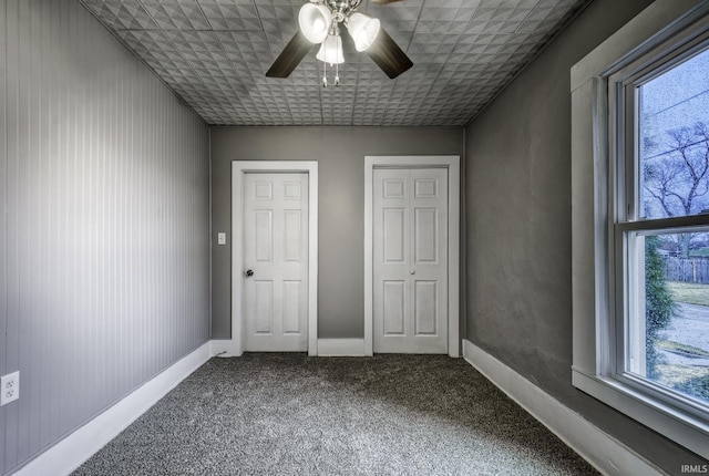 unfurnished bedroom with carpet floors, ceiling fan, and baseboards