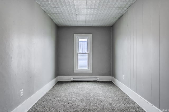 carpeted spare room featuring baseboards and baseboard heating