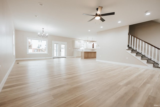 unfurnished living room with stairs, light wood finished floors, recessed lighting, and baseboards