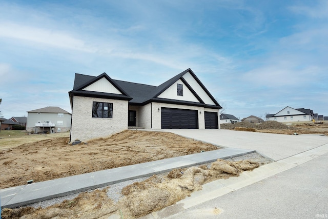 view of front of house featuring driveway and brick siding