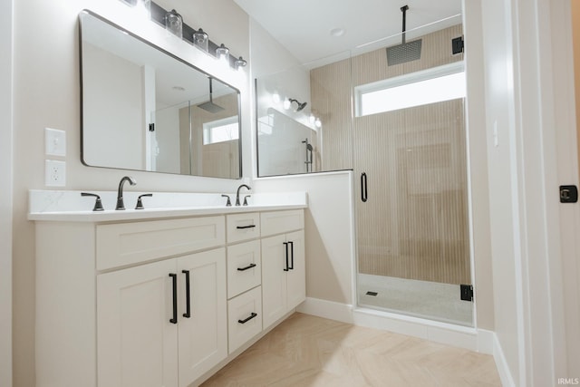 bathroom with a sink, a shower stall, and double vanity