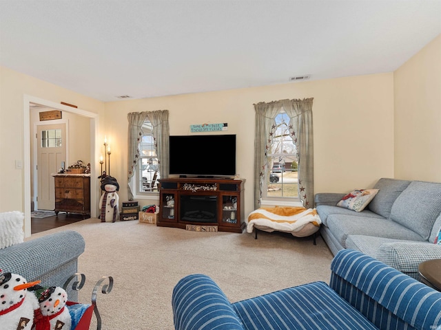 carpeted living area featuring visible vents