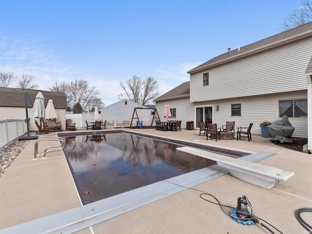 view of swimming pool featuring outdoor dining space, a fenced backyard, a fenced in pool, and a patio