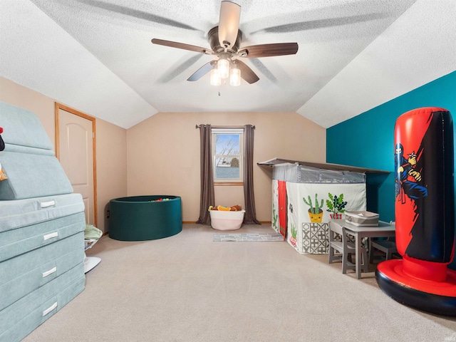 additional living space featuring vaulted ceiling, ceiling fan, a textured ceiling, and carpet flooring