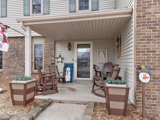 view of exterior entry with brick siding