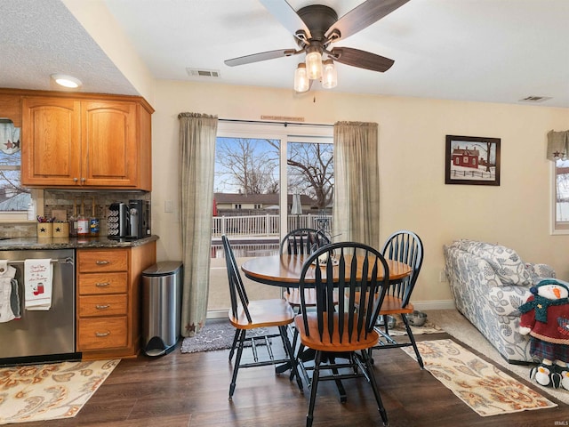 dining area with a ceiling fan, baseboards, visible vents, and dark wood-style flooring