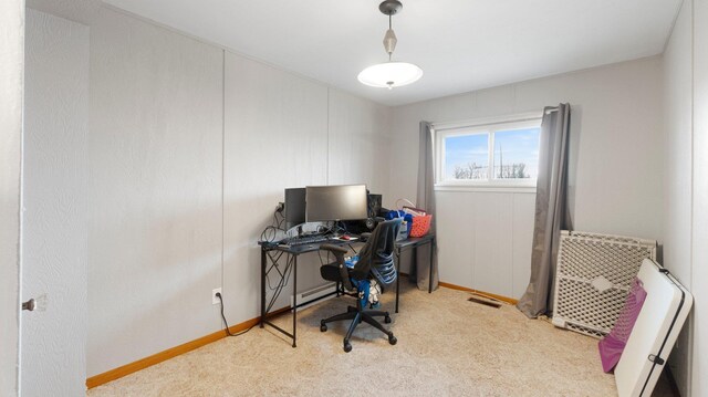 carpeted home office featuring baseboards