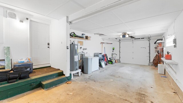 garage with a garage door opener and electric water heater