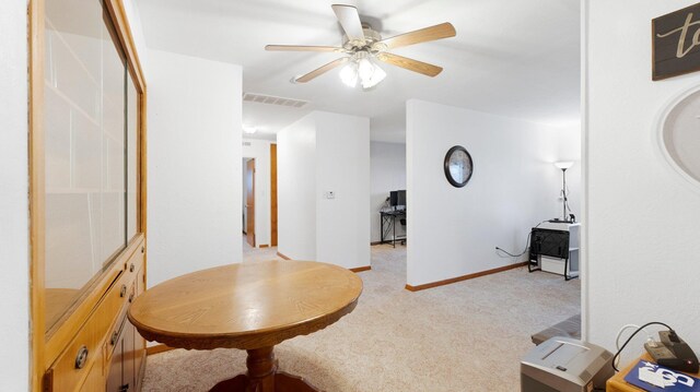 dining space with light carpet, baseboards, visible vents, and a ceiling fan