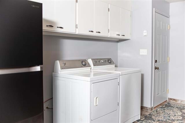 washroom with cabinet space and washing machine and clothes dryer