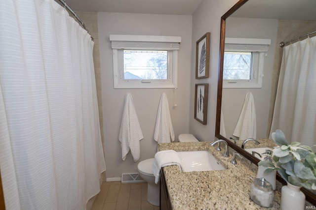 bathroom with visible vents, a shower with shower curtain, toilet, vanity, and wood finished floors