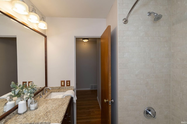 bathroom featuring visible vents, vanity, and wood finished floors