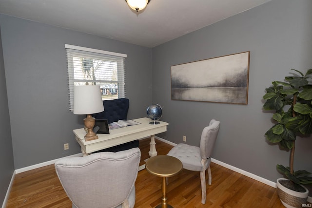 office space featuring baseboards and wood finished floors