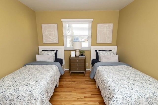 bedroom with baseboards and light wood finished floors