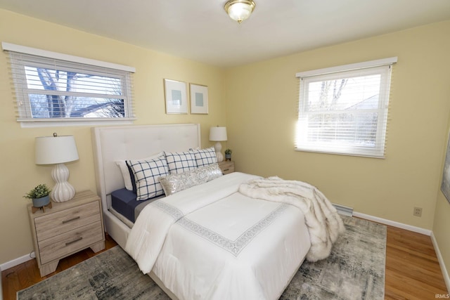 bedroom featuring baseboards and wood finished floors