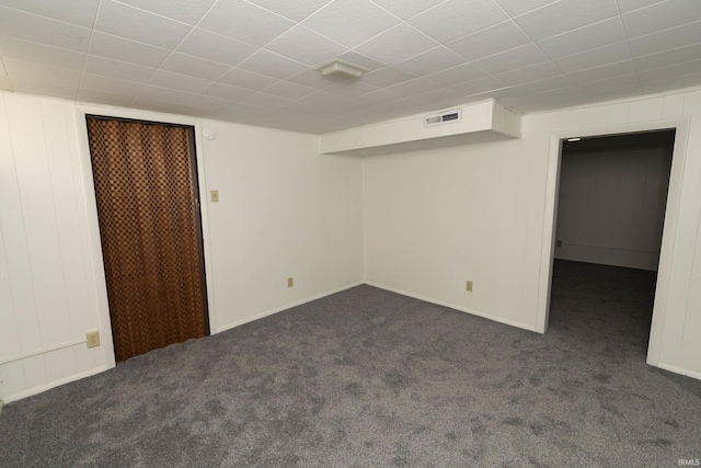 below grade area with carpet floors and visible vents