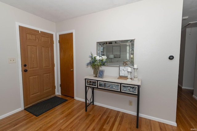 entrance foyer with light wood-type flooring and baseboards