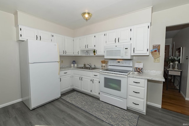 kitchen featuring white appliances, light countertops, dark wood finished floors, and white cabinetry