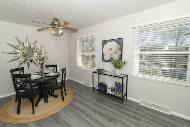 dining area featuring ceiling fan, dark wood finished floors, visible vents, and baseboards