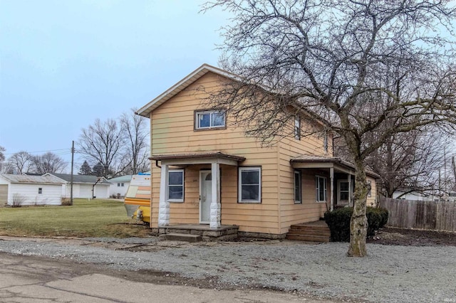 view of front of home featuring fence and a front yard