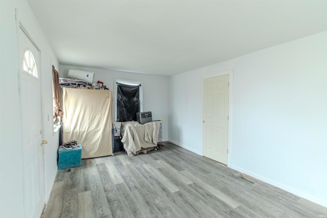 unfurnished bedroom featuring light wood finished floors and baseboards