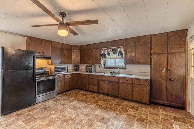 kitchen with a sink, under cabinet range hood, stainless steel appliances, and light countertops