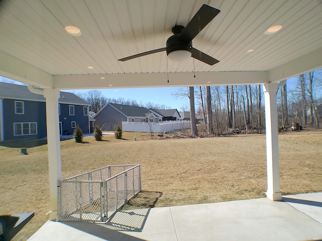 view of patio / terrace with ceiling fan and fence