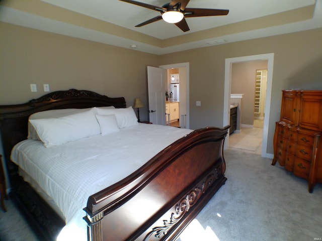 bedroom with visible vents, light carpet, connected bathroom, ceiling fan, and baseboards