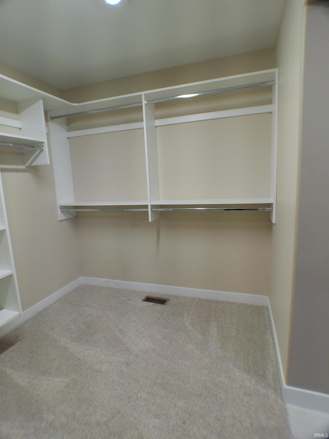 walk in closet featuring visible vents and carpet flooring