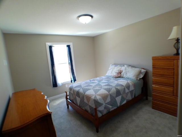 carpeted bedroom featuring baseboards