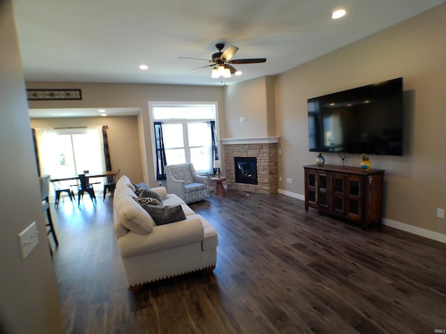 living room with recessed lighting, a fireplace, baseboards, and wood finished floors