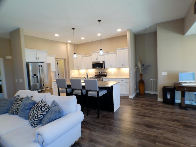 living area with baseboards, dark wood-type flooring, and recessed lighting