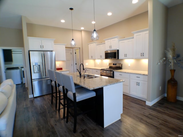 kitchen featuring dark wood-type flooring, white cabinetry, stainless steel appliances, and a sink