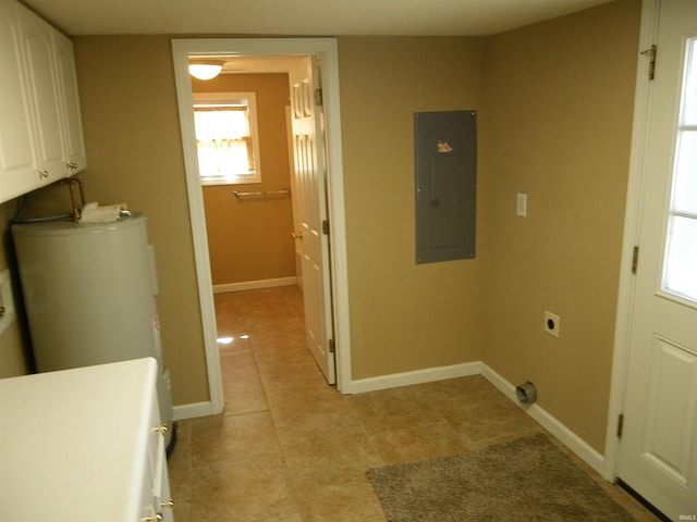 clothes washing area with cabinet space, water heater, hookup for an electric dryer, electric panel, and baseboards